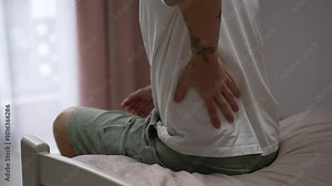 A man has back problems. Severe pain in the back. A man suffers from back pain. Lumbar stretch. A guy has back problems. Pain, back, sprain, lower back, posture
