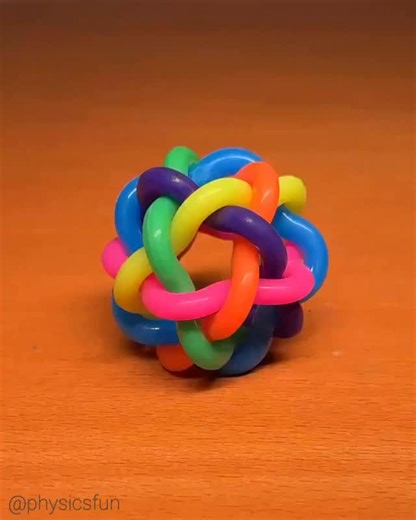 Icosidodecahedron Bouncy Ball: this bouncy ball contains some fun mathematical symmetries which is explored showing the same shape when viewed after rotations. Just six interlocking wavy shaped loops (pink, blue, green, purple, orange, yellow) weave together to create 12 pentagonal faces along with 20 triangular faces. Each loop also forms an equatorial great circle, producing the underlying polyhedral form of this toy, an icosidodecahedron. ➡️ Follow the link in my profile for info on where to 