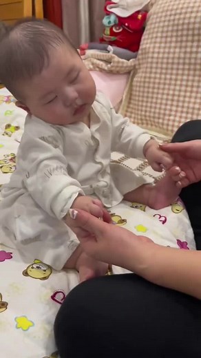 Adorable Baby in Cute Onesie with Supportive Care