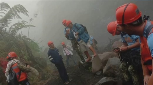 Rescuers climb an active volcano to reach plane crash site in Philippines