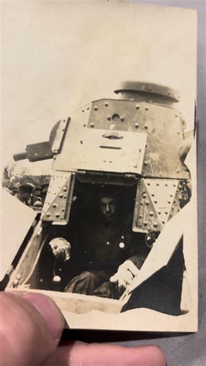 Soldier / Tanker most likely French WW1 in the Renault tank next to civilians looking at the machine