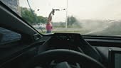 The video shows a view from inside as a woman cleans the car...