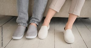 Low section of playful couple touching each others legs