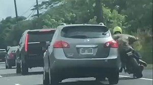 Biker smashes window of SUV before the driver crashes into him