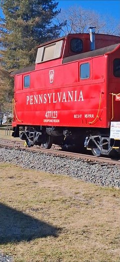 the restored 1917 Pennsylvania railroad red caboose display and steam locomotive tender in lewes de.