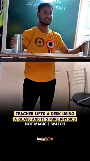 @lndiawire on Instagram: "A classroom experiment is going viral after a teacher lifts an entire desk using just a glass, paper, water, and fire. At first glance, it looks like magic but it’s actually a simple demonstration of physics. The teacher creates a vacuum inside an inverted glass by heating the air and then letting it cool. As the pressure inside drops, the higher atmospheric pressure outside pushes the glass firmly against the surface, making it strong enough to lift the desk. The exper