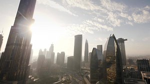 Time lapse of the sun sets behind the skyline of the city at sunset light
