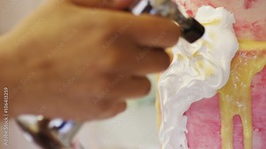 Baker using cook's blowtorch to toast meringue on a cake, in slow motion
