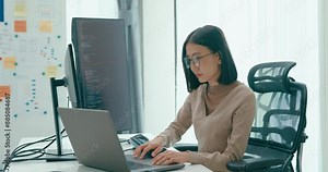 Young adult Asia female freelance eyeglasses typing write prompt AI bot IT app smart program nomad, video game, terminal with coding, user interface, designer, big data center on desktop computer. Stock Video