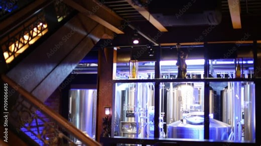 Microbrewery equipment behind window in restaurant.