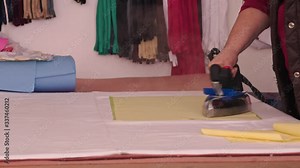 Woman ironing fabric with industrial steaming iron tool