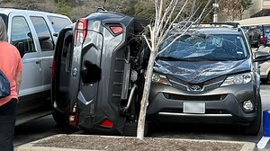 Car gets wedged in H-E-B parking lot in The Woodlands