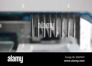 Close up of automatic PCR nucleic acid extraction station processing samples with precision tools for molecular diagnostics and genetic analysis in modern laboratory environment.