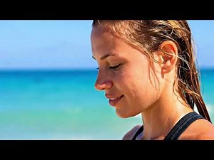 Focused Athletic Woman Harnessing Ocean Energy During a Calm Beach Fitness Flow #BeachFitness