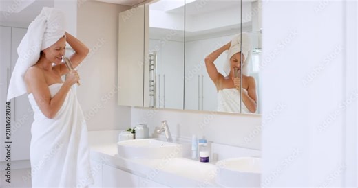 Bathroom, dance and woman singing with brush in home for self care, haircare and energy in mirror. Happy person, karaoke and confidence in house with towel for hygiene, grooming and wellness