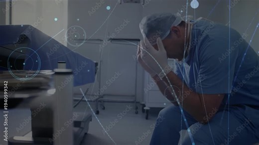 Male surgeon viewing covered table or trays bowing head, processing as overlays brightening around h
