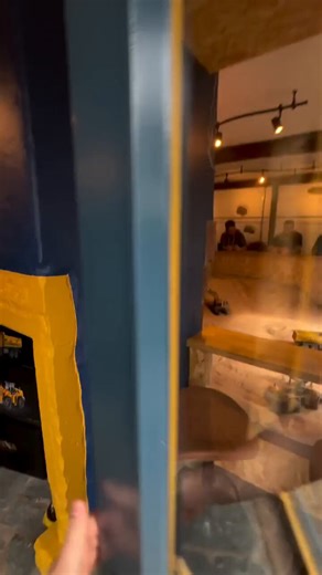 There is a cafe in Cumbria, England where a large indoor sandpit allows customers to operate remote-controlled construction trucks and excavators from their seats.