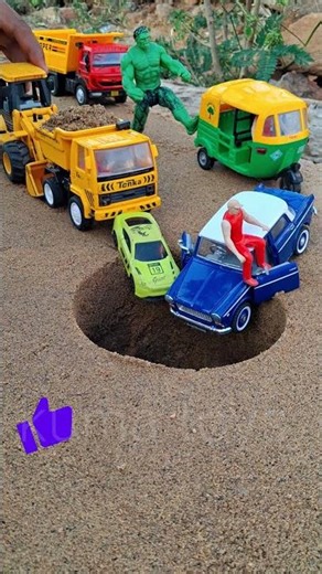 blue car jk jcb pushing and tipper truck and cars in to pit autorickshaw and hulk near