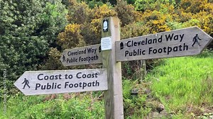 Close up of a footpath sign or finger post with directions for the Coast to Coast and Cleveland Way long distance footpaths in the North York Moors National Park - Nr Osmotherley, North Yorkshire, UK