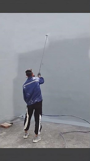 Spray technique applying waterproof paint on exterior walls for durable protection #construction