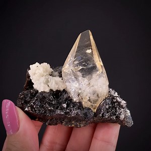 Calcite and Baryte on Sphalerite - Elmwood Mine, Carthage, Smith Co., Tennessee, USA More info: https://www.irocks.com/minerals/specimen/52328 An old specimen from 1980s production at the famous Elmwood Mine in Tennessee, this piece features a jewel-like, gemmy, transparent to translucent calcite crystal so perfectly balanced on spaherlite matrix! We obtained it long ago from the Consie and Dalton Prince collection (they were major dealers and collectors of the 1970s-90s, based out of Houston, a