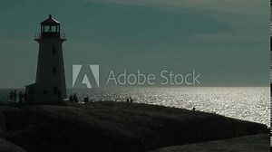 Peggys Point Lighthouse silhouette sunset, canada Peggys Point Lighthouse in the fishing village of Peggys Cove in Nova Scotia Canada