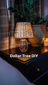 This lamp looks designer, but it started with Dollar Tree pieces 🤯 I turned a candle holder, glass, basket, and lights into a cordless table lamp and it completely changed the vibe of the space. I just shared the full video with this project plus the rest of the high-end Dollar Tree DIYs. Comment DUPE and I’ll send you the link to the new video with all the tutorials! ✨ #dollartreediy #budgetdecor #CozyHome | Cozy DIY Home