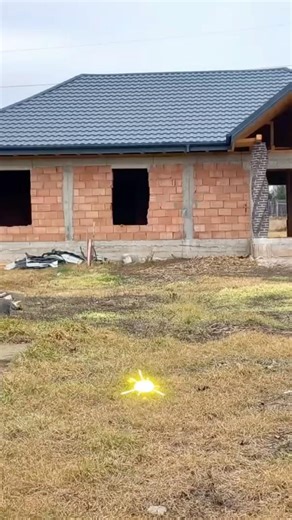 This unfinished brick house was transformed with AI into a modern home with garden, pavers and light