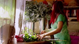 Florist woman doing flower bouquet. Small business owner working in shop.