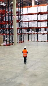 Logistics engineer walking in warehouse