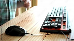 Man sitting at a table and using his computer mouse Stock Video