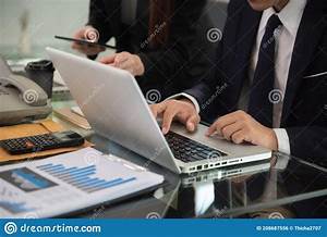 Businessman And Partner Using Calculator And Laptop For Calculation