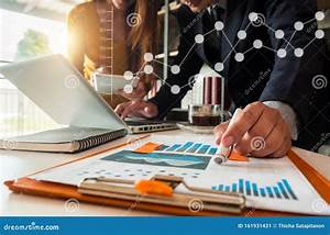Businessman And Partner Using Calculator And Laptop For Calculation