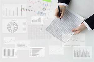Business Mans Hand Analyzing With Various Charts And Graphs Stock Photo