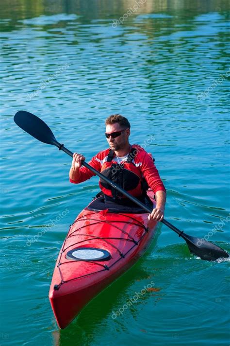 man in kayak on lake