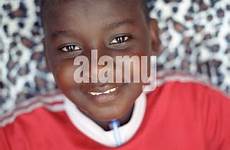 boy teenaged kenya african camera stock standing beach his back alamy wearing looks shirt red looking