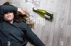 drunk young drinking bottle sick floor girl woman lying alcoholic feeling empty wine glass red stock sleeping sofa alamy