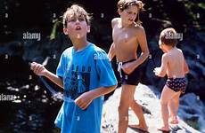 hole swimming pool boys summer young river outside playing fix alamy hanging together