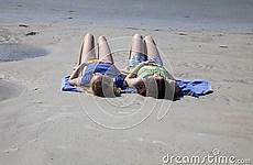 beach two girls sunbathing teenage stock