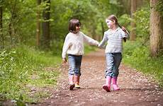 hands sisters holding walking two path smiling stock girl help girls friendships navigate sister stress ticks disease lyme panic guide