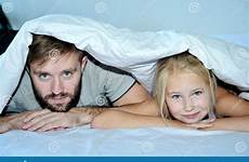 daughter father bed together relaxing looking preview