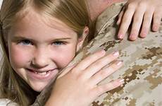 daughter hugging military dad happy