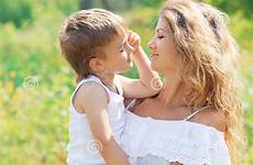 hugging son mother outdoors portrait child summer preview