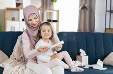 hijab applying pouring lotion mother