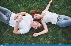lying people grass couple cheerful young harmony happiness outdoors