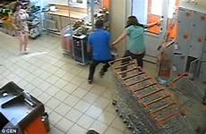 shoplifter male store russia wrestle kick captures cctv moment women alcohol stolen shop exit block he supermarket kolomna cognac whiskey