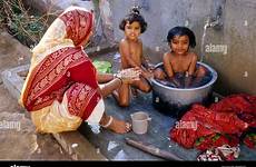 bathing india mother indian kids washing public bucket her village bhujodi daughters gujarat stock alamy hot