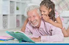 granddaughter grandfather reading book his