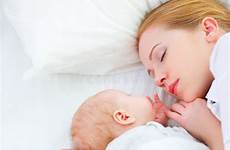 mother baby sleeping together newborn bed embraces stock