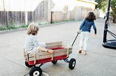 pulling wagon boy toy brother rear yard dissolve stock cavan d1061